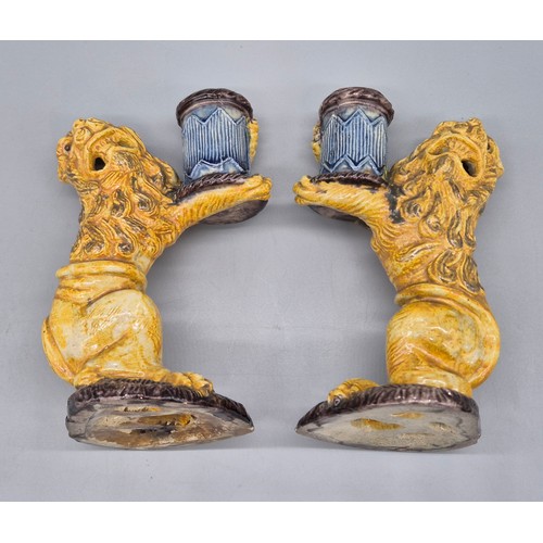 127 - A Pair of antique Majolica lion candle stick holders. [16cm high] [Old repairs to base]