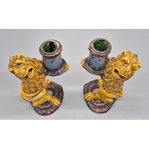 127 - A Pair of antique Majolica lion candle stick holders. [16cm high] [Old repairs to base]