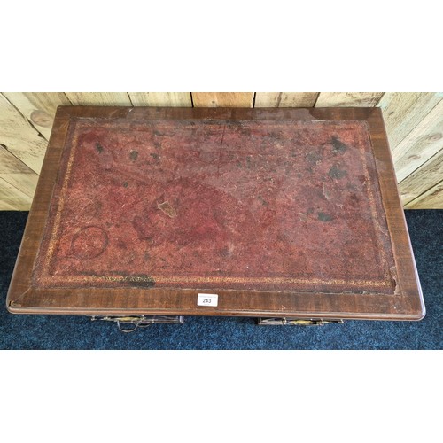 243 - Early 19th century leather top desk, fitted with brass swing handles. Rectangle top fitted with red ... 