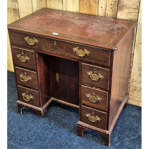 243 - Early 19th century leather top desk, fitted with brass swing handles. Rectangle top fitted with red ... 