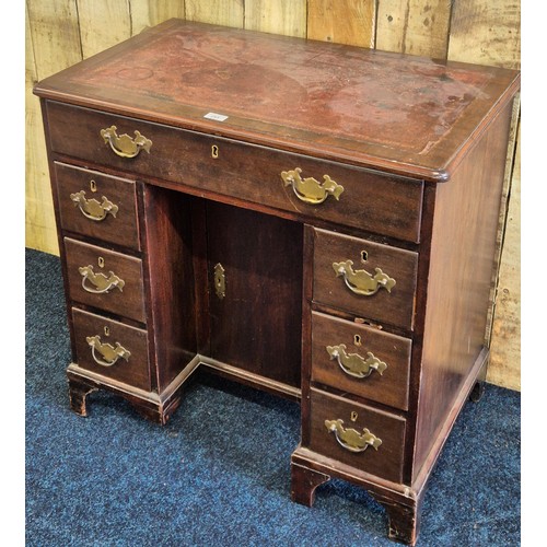 243 - Early 19th century leather top desk, fitted with brass swing handles. Rectangle top fitted with red ... 