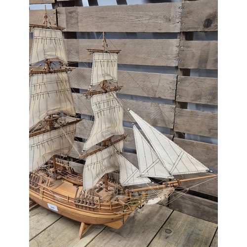 244 - Large hand made wooden  galleon ship raised on a stand [64x77cm]