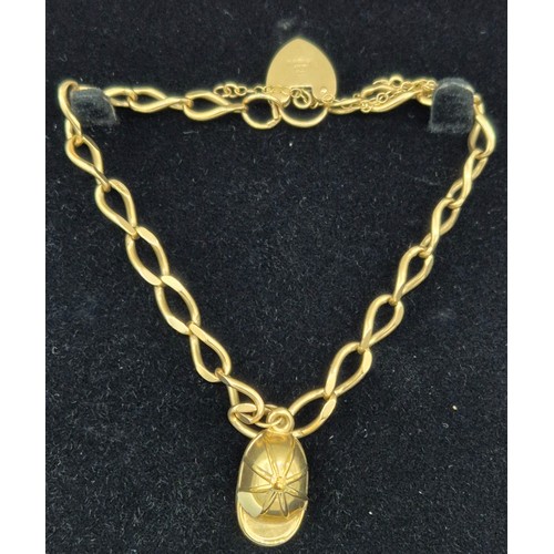 7 - 9ct yellow gold bracelet fitted with cap charm and heart lock. [9.08grams]