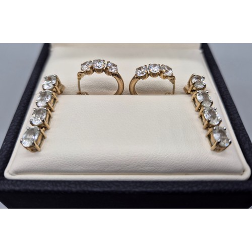 25 - Two pairs of 9ct yellow gold earrings fitted with white glass stones. [4.72grams]