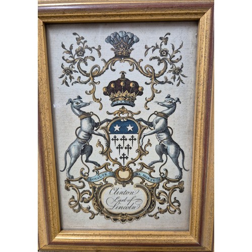 56 - Four 19th century coloured engraving family crests. Fitted within matching frames [22.5x16.5cm]