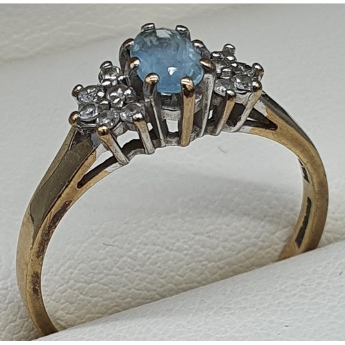 18 - 9ct yellow gold ring fitted with an oval cut aquamarine gemstone and diamond cluster. [Ring size R] ... 