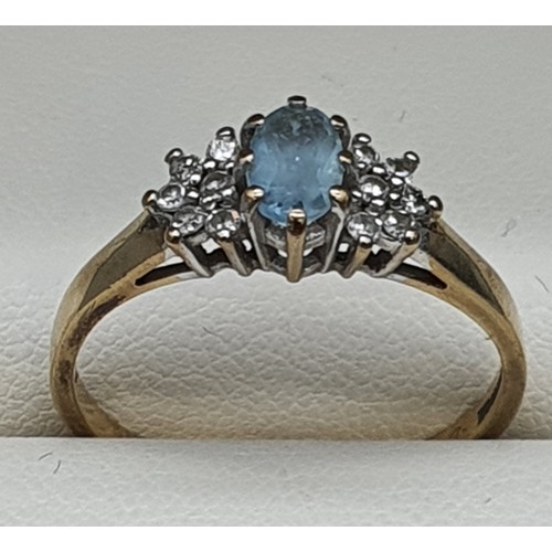 18 - 9ct yellow gold ring fitted with an oval cut aquamarine gemstone and diamond cluster. [Ring size R] ... 