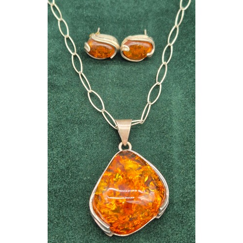 69 - 925 silver and amber pendant and necklace, together with a pair of silver and amber earrings.