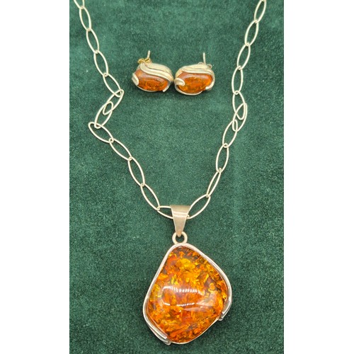 69 - 925 silver and amber pendant and necklace, together with a pair of silver and amber earrings.