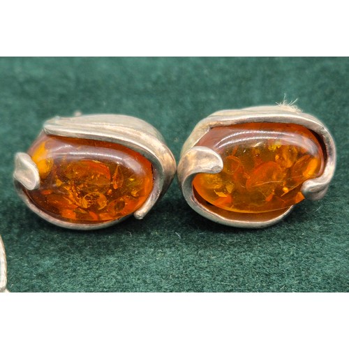 69 - 925 silver and amber pendant and necklace, together with a pair of silver and amber earrings.