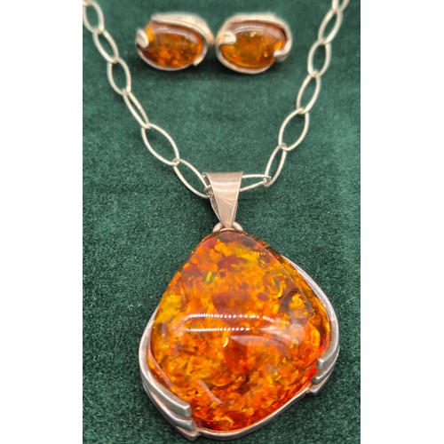 69 - 925 silver and amber pendant and necklace, together with a pair of silver and amber earrings.