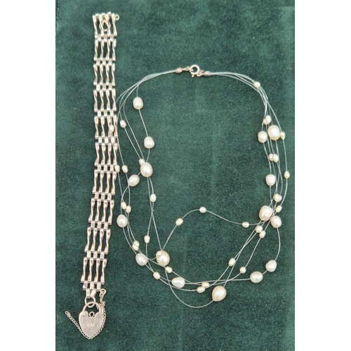 63 - Silver gate bracelet, together with a silver and fresh water pearl necklace.