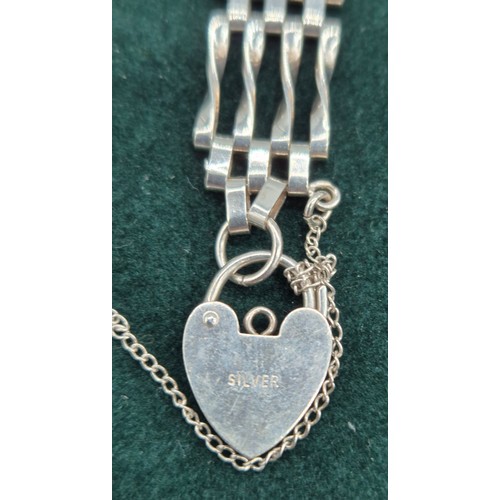 63 - Silver gate bracelet, together with a silver and fresh water pearl necklace.