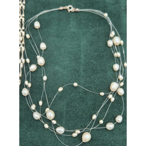 63 - Silver gate bracelet, together with a silver and fresh water pearl necklace.