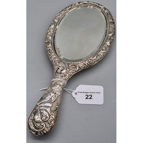 22 - Birmingham silver raised relief hand mirror, detailing cherub figures and scroll effect. [27cm lengt... 