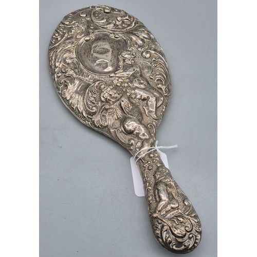 22 - Birmingham silver raised relief hand mirror, detailing cherub figures and scroll effect. [27cm lengt... 