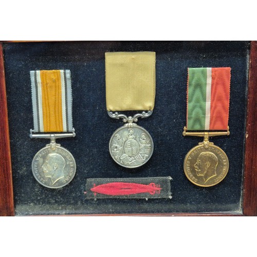 50 - Three Framed WWI Medals and Torpedo Badge belonging to James J. Michie. War Medal, Long Service meda...