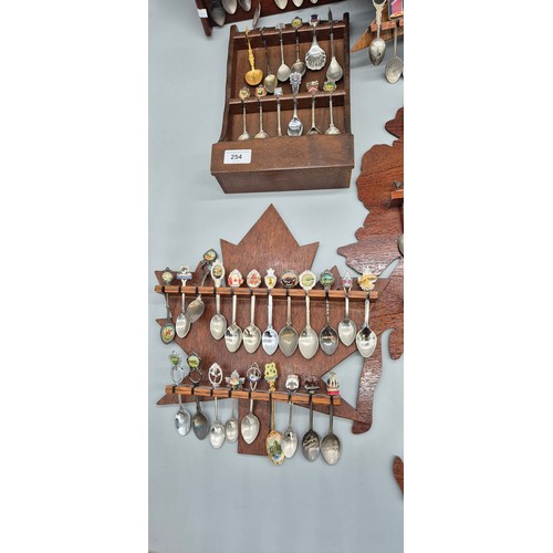 254 - A Large Collection of Souvenir Spoon racks and spoons.