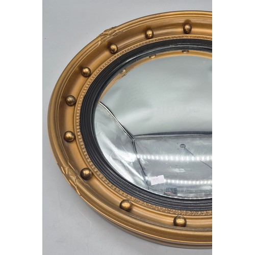 245 - Regency style gilt framed convex mirror, fitted with ball design. [48cm diameter]