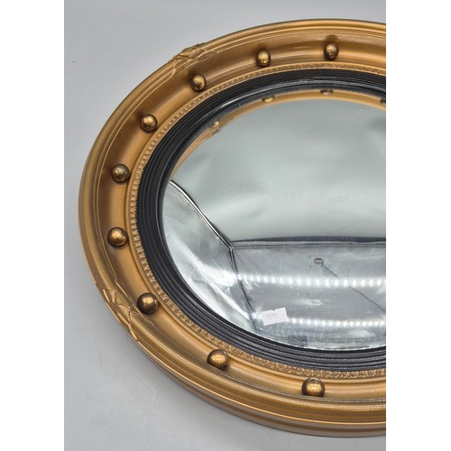 245 - Regency style gilt framed convex mirror, fitted with ball design. [48cm diameter]