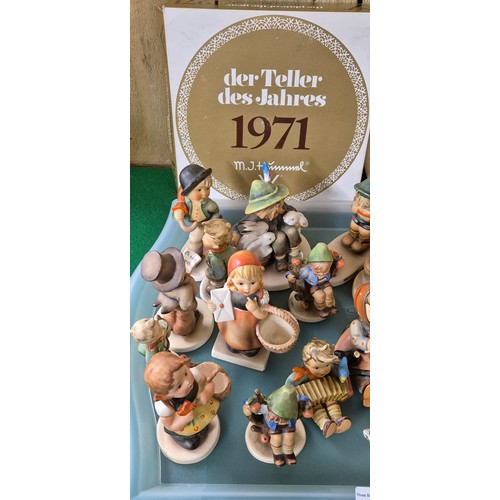 351 - A Large Collection of Goebel Hummel pottery figurines & collector plate boxed. [As found]