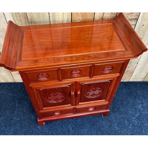 211 - Chinese Rosewood console unit. Three small drawers over two doors over two drawers. [85x74x35.5cm]