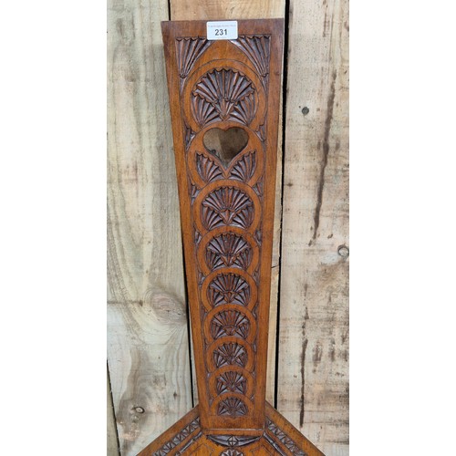 231 - 20th century Spinning wheel chair on turned supports. Having a carved design. [97x30x40cm]