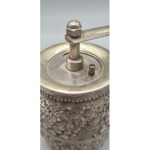 69 - White metal Pepper Mill Grinder. Designed with raised relief Indian buddha figures.