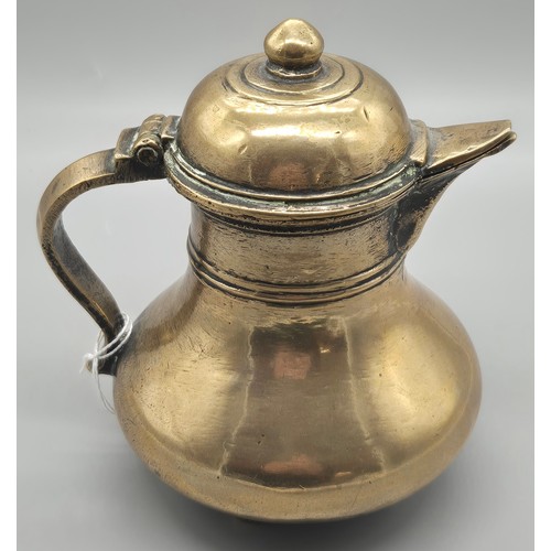 123 - Two pieces of Indian brass and Bronze wares; Bronze Four foot coffee pot and Brass Urn fitted with v... 