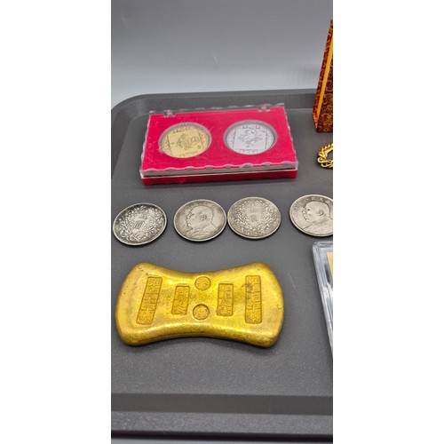 97 - A tray of Chinese Coins and ingots; Brass and silver plated ingot. Various loose and cased coins and... 