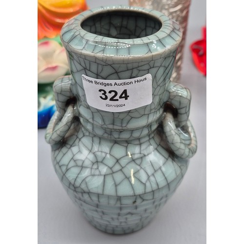 324 - Four various Asian collectables; Chinese celadon green and crackle glaze vase, Laughing buddha sculp... 