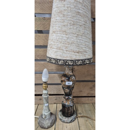 267 - Two various table lamps; heavy marble table lamp with shade and carved granite stone lighthouse shap... 