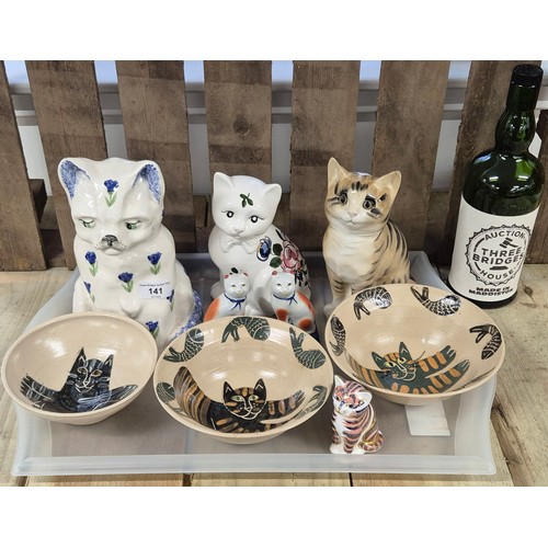 141 - Tray of collectable porcelain cat figures and studio pottery; Three studio pottery cat design bowls ... 