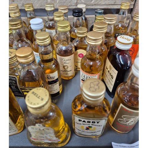 162 - A Tray containing a large quantity of mixed whisky miniatures; Johnnie Walker, Bell's, Hankey banist... 