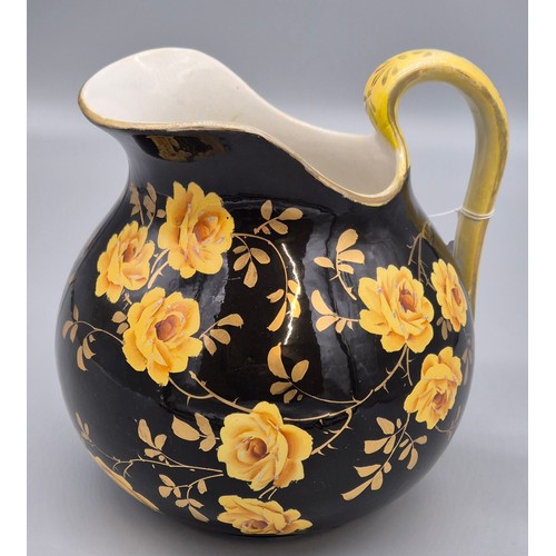 317 - Rare antique Wemyss ware Yellow rose design water jug. Black ground. Having a sticker to the undersi... 