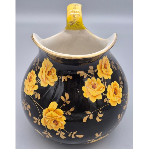 317 - Rare antique Wemyss ware Yellow rose design water jug. Black ground. Having a sticker to the undersi... 