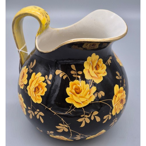 317 - Rare antique Wemyss ware Yellow rose design water jug. Black ground. Having a sticker to the undersi... 