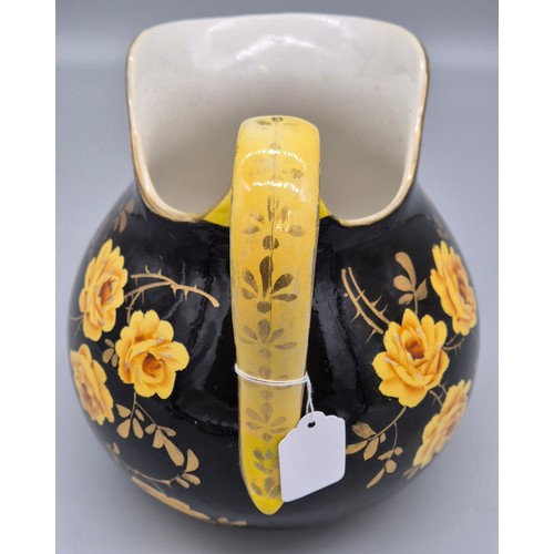 317 - Rare antique Wemyss ware Yellow rose design water jug. Black ground. Having a sticker to the undersi... 