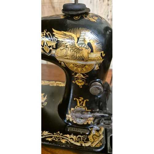 386 - Early 20th century cast iron base singer Sewing machine. Egyptian motif style.