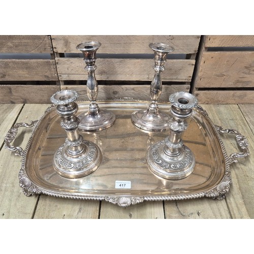 417 - A Large antique E.P Two handle ornate serving tray together with two pairs of candlesticks