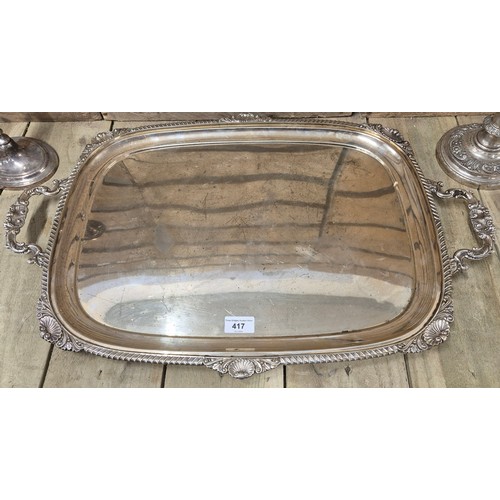 417 - A Large antique E.P Two handle ornate serving tray together with two pairs of candlesticks