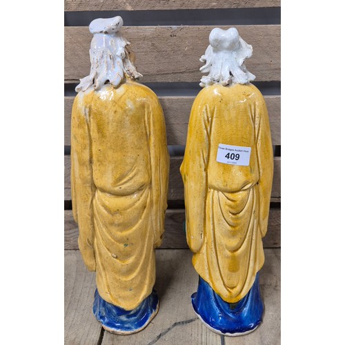 409 - A Pair of Chinese Drip glaze figurines. Stamped to the underside. [38cm high]