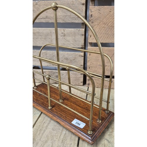 396 - Art Deco Magazine rack. Brass and oak made. Stamped S.H.&.S To the underside.