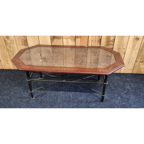 522 - Coffee table; made up of an Indian rosewood and inlaid top section and wrought iron base. [44x110x56... 