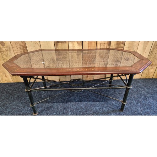 522 - Coffee table; made up of an Indian rosewood and inlaid top section and wrought iron base. [44x110x56... 