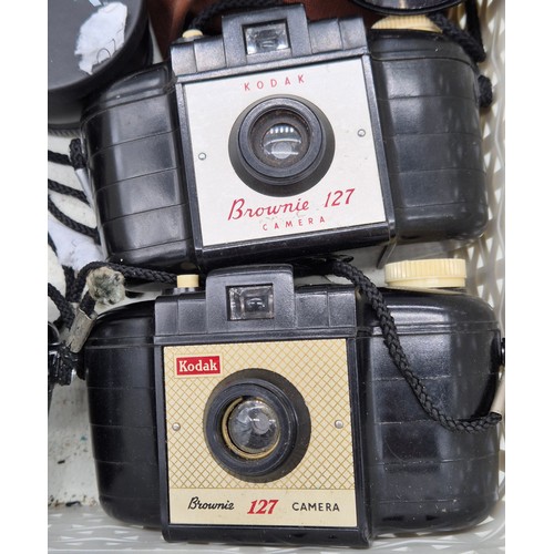 550 - A Basket of mixed cameras and binoculars; Theatre glasses, Kodak cameras and various lenses.