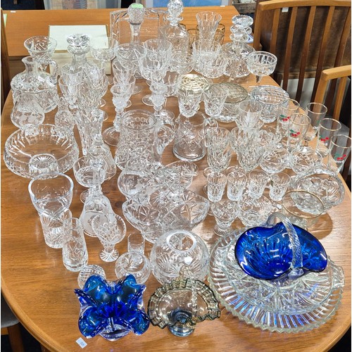 552 - A Large collection of crystal and glass ware; Decanters, candlesticks, vases and drinking glasses