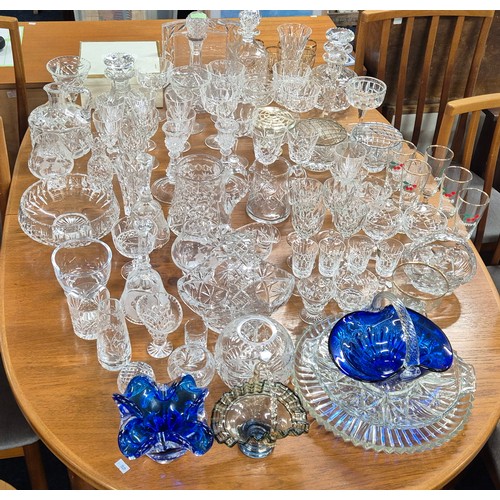 552 - A Large collection of crystal and glass ware; Decanters, candlesticks, vases and drinking glasses