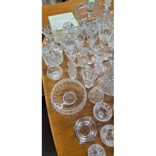 552 - A Large collection of crystal and glass ware; Decanters, candlesticks, vases and drinking glasses