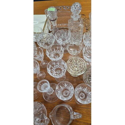 552 - A Large collection of crystal and glass ware; Decanters, candlesticks, vases and drinking glasses